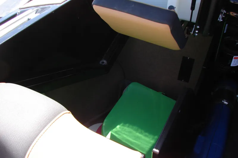 Slide: The Image of Interior view of a 2021 MasterCraft X26 boat, featuring seating and storage area. - 28