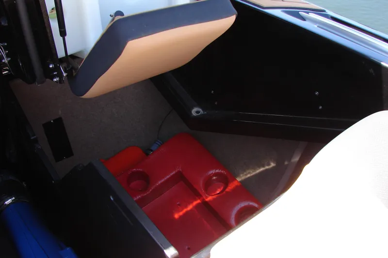 Slide: The Image of Interior storage compartment of 2021 MasterCraft X26 boat with red and beige accents. - 29