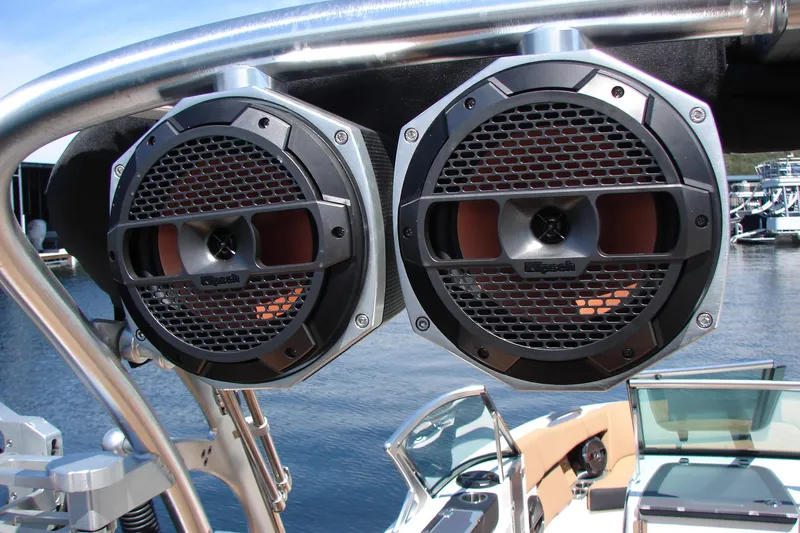 Slide: The Image of MasterCraft X26 2021 boat with Klipsch speakers on a sunny day by the water. - 32