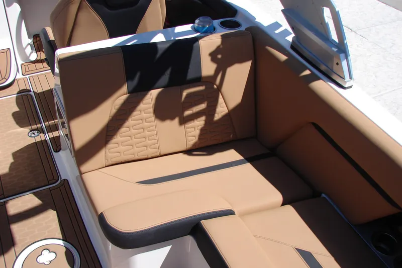 Slide: The Image of Luxurious tan seating in 2021 MasterCraft X26 boat, featuring sleek design and cup holder. - 33
