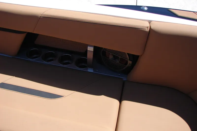 Slide: The Image of 2021 MasterCraft X26 boat interior with tan seating and cup holders. - 34