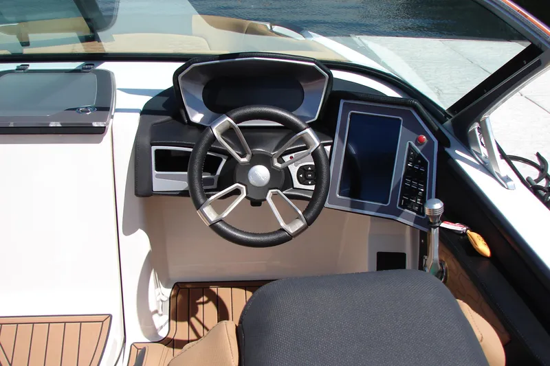 Slide: The Image of 2021 MasterCraft X26 boat cockpit with modern steering wheel and digital controls. - 37