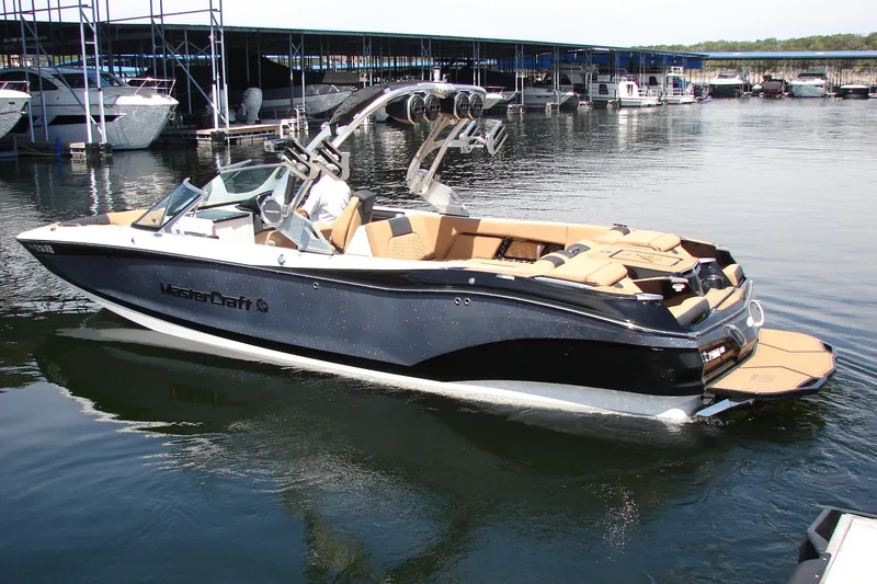 Slide: The Image of 2021 MasterCraft X26 boat docked in marina, featuring sleek design and luxurious seating. - 7