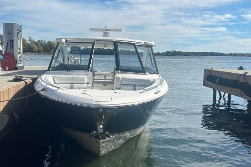 Slide: The Image of 2025 Regal LS36 boat docked at a marina on a sunny day. - 12