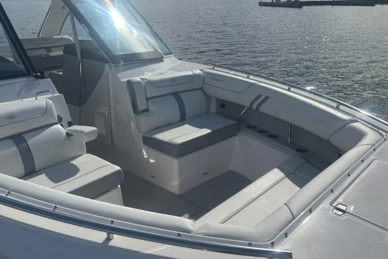 Slide: The Image of Luxurious seating area on 2025 Regal LS36 boat, overlooking serene water. - 14