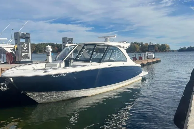 Slide: The Image of 2025 Regal LS36 boat docked at a marina under a clear blue sky. - 17