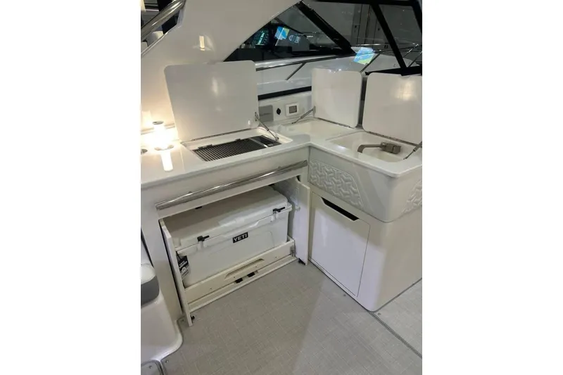 Slide: The Image of 2025 Regal LS36 yacht kitchenette with grill, sink, and Yeti cooler. - 3