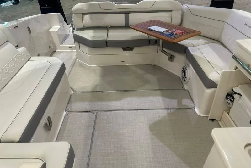 Slide: The Image of Luxurious interior of 2025 Regal LS36 boat with plush seating and wooden table. - 8