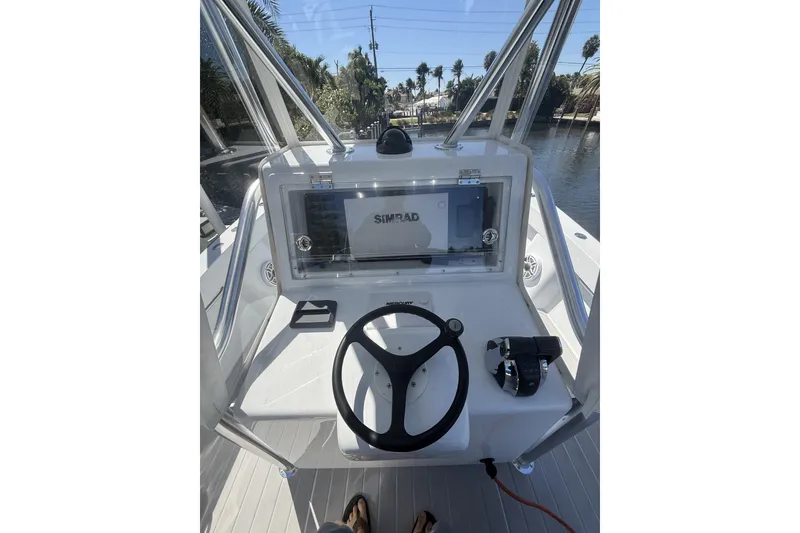 Slide: The Image of 2015 Conch 27 boat docked near waterfront home with palm trees. - 10