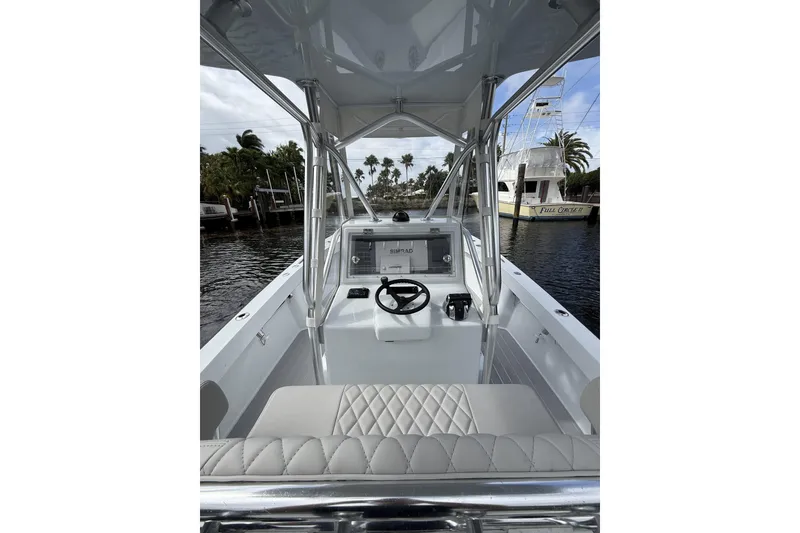 Slide: The Image of Interior view of 2015 Conch 27 boat with steering console and seating. - 18