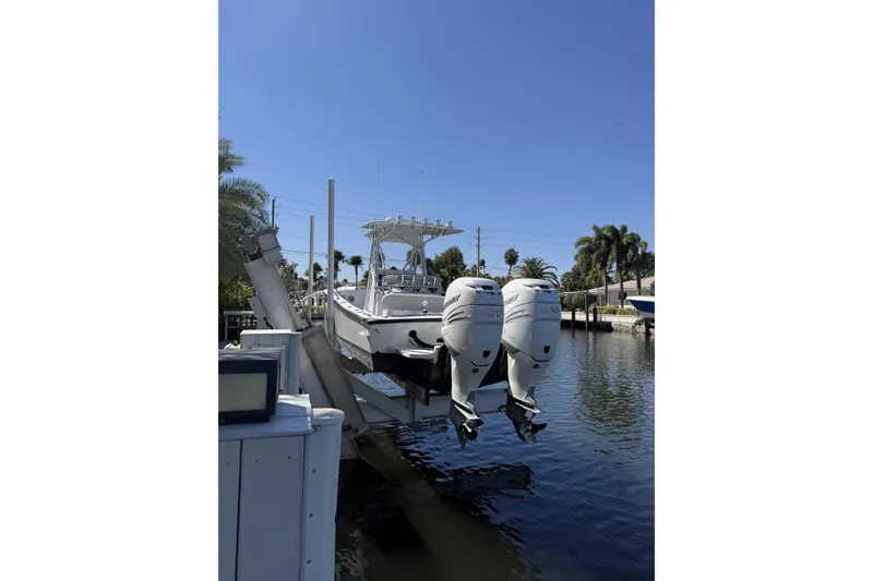 Slide: The Image of 2015 Conch 27 boat docked in a scenic waterfront setting. - 2