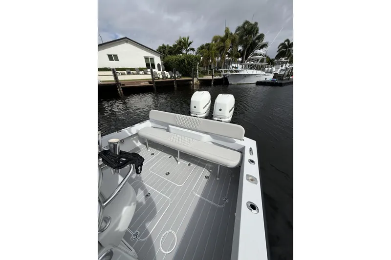Slide: The Image of 2015 Conch 27 boat with dual engines docked by waterfront homes. - 21