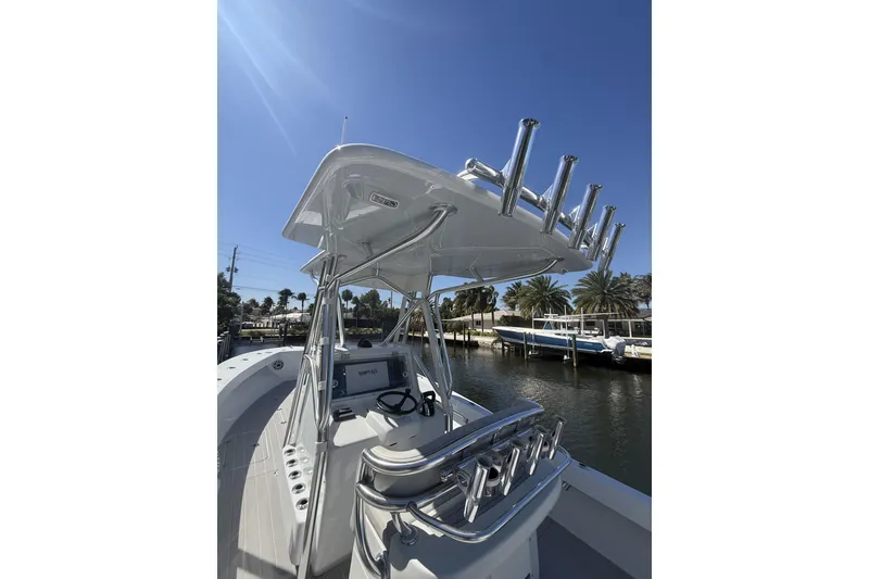 Slide: The Image of 2016 Conch 27 boat with dual outboard engines docked on calm water. - 9