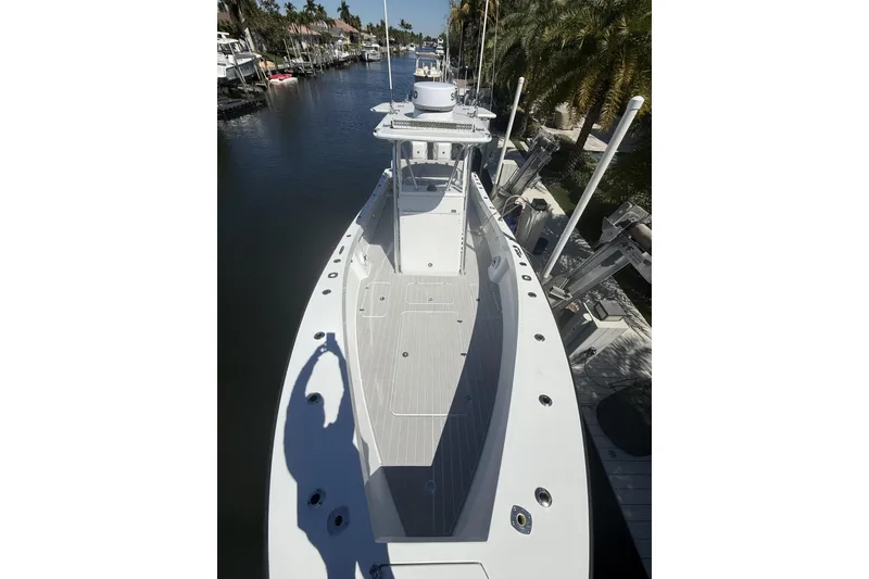 Slide: The Image of 2016 Conch 27 boat docked in a serene marina setting. - 4