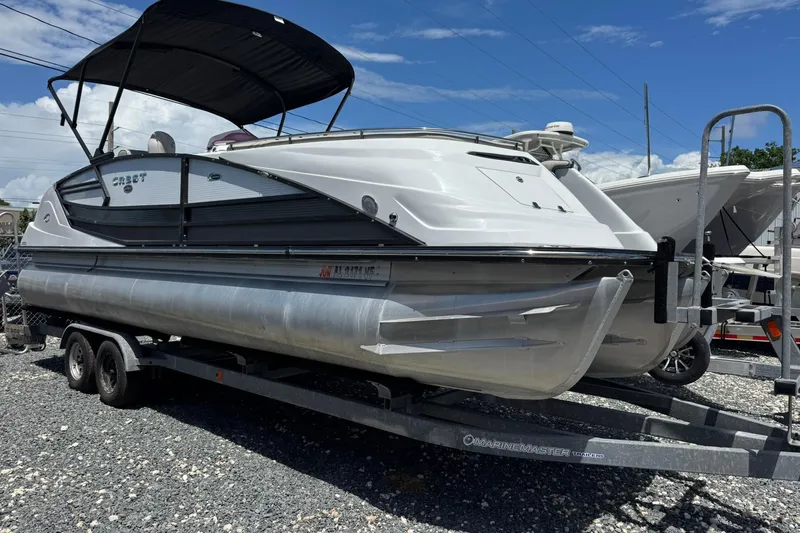 The Image of 2020 Crest Savannah 250 SLRC pontoon boat on trailer, parked outdoors. - 0