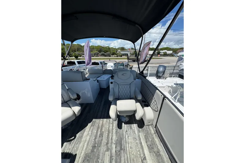 Slide: The Image of 2020 Crest Savannah 250 SLRC boat interior with luxurious seating and canopy. - 10