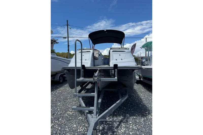 Slide: The Image of 2020 Crest Savannah 250 SLRC pontoon boat on trailer under blue sky. - 2