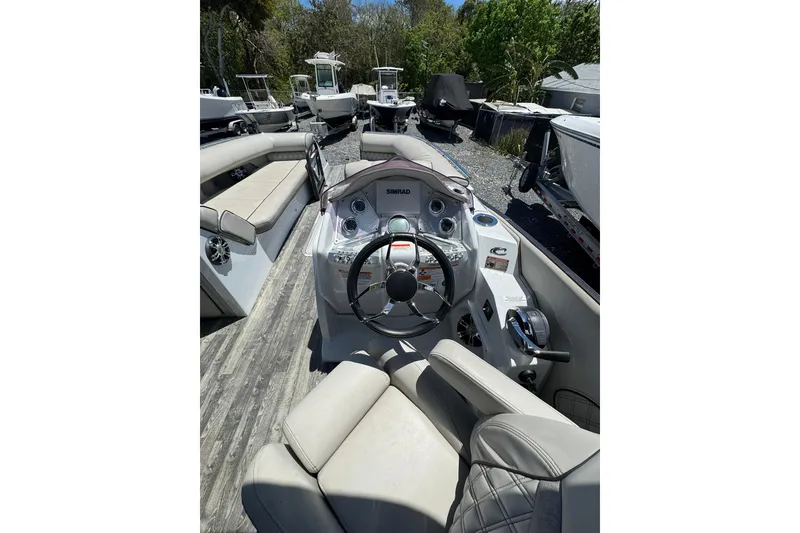 Slide: The Image of 2020 Crest Savannah 250 SLRC boat interior with steering console and seating. - 9