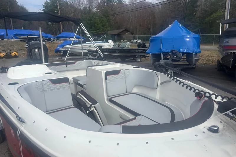 Slide: The Image of 2023 Bayliner Element E17 boat with spacious seating, parked outdoors. - 9