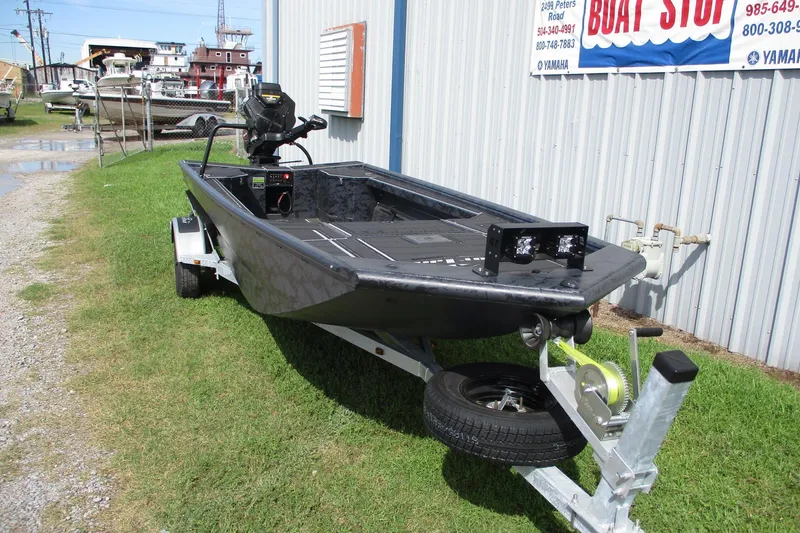 Slide: The Image of 2026 Gator Tail 1854 Extreme boat on trailer outside dealership. - 2
