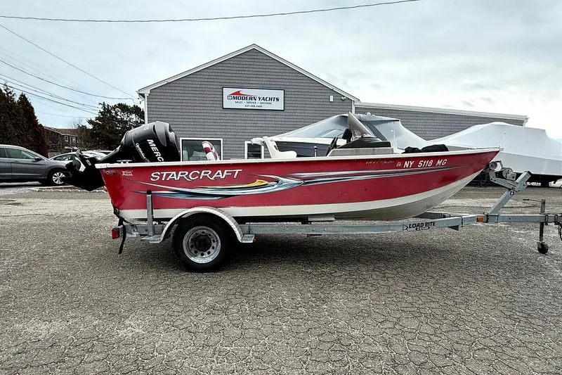 The Image of 2008 Starcraft Starfire 1700 SC boat on trailer, parked outside Modern Yachts building. - 0