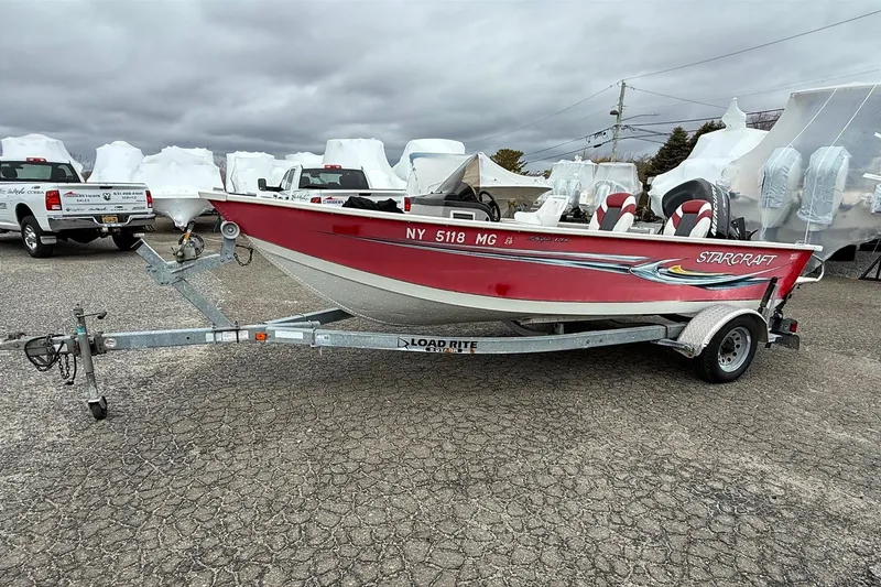 Slide: The Image of 2008 Starcraft Starfire 1700 SC boat on trailer, parked outdoors. - 2