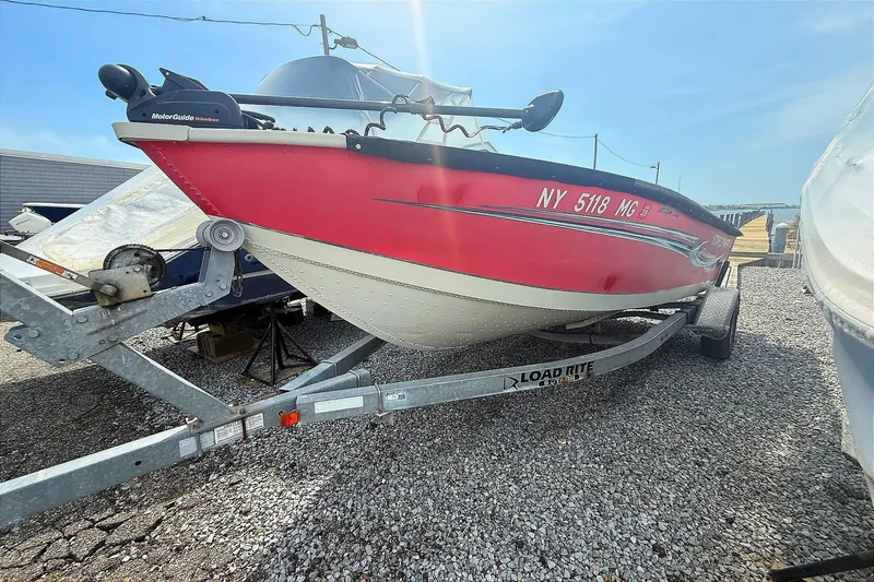 Slide: The Image of Red 2008 Starcraft Starfire 1700 SC boat on a Load Rite trailer, parked on gravel. - 5
