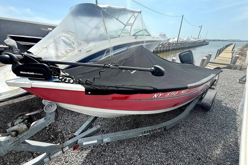 Slide: The Image of 2008 Starcraft Starfire 1700 SC boat on trailer, covered, near dockside. - 6