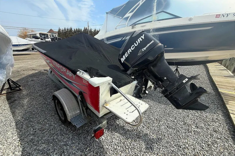 Slide: The Image of 2008 Starcraft Starfire 1700 SC boat with Mercury Optimax engine on trailer. - 7