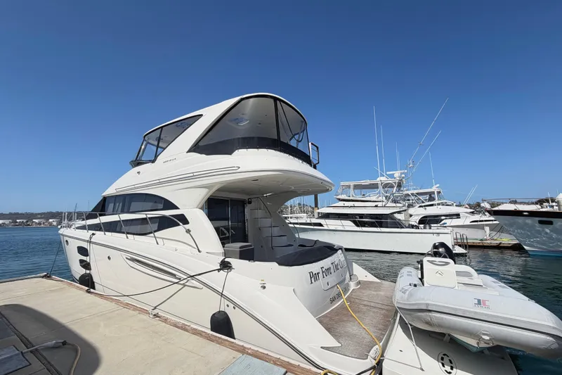 Slide: The Image of 2009 Meridian 411 Sedan yacht docked at marina under clear blue sky. - 1