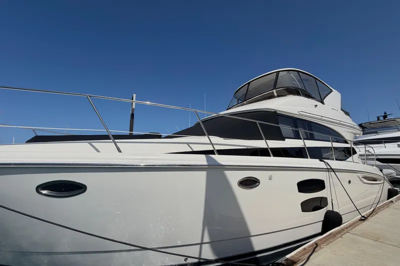 The Image of 2009 Meridian 411 Sedan yacht docked under clear blue sky. - 0