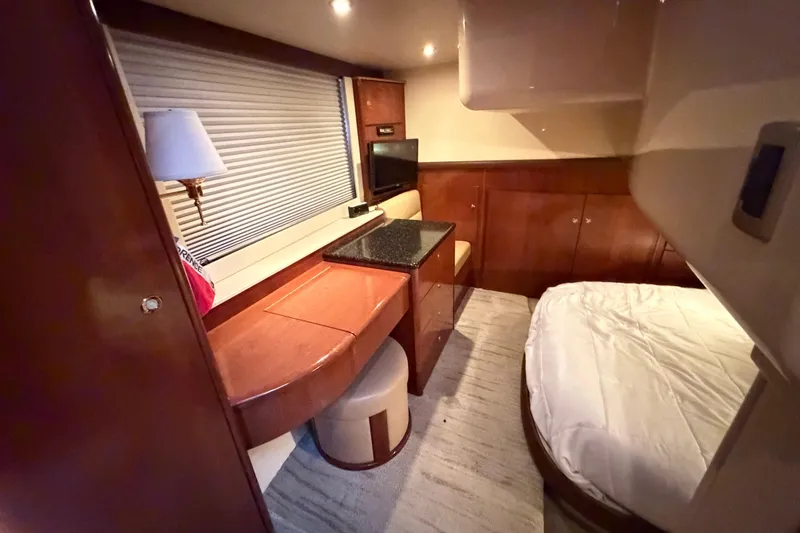 Slide: The Image of Luxurious interior of 2009 Meridian 441 Sedan yacht with wood furnishings and cozy bed. - 11