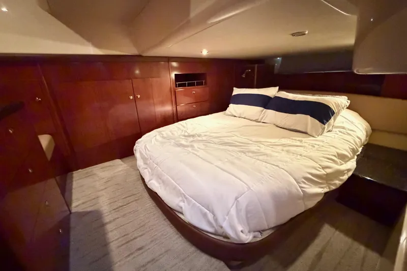 Slide: The Image of Luxurious bedroom interior of 2009 Meridian 441 Sedan yacht with cozy bedding and wooden cabinetry. - 12