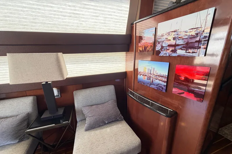 Slide: The Image of Interior of 2009 Meridian 441 Sedan yacht with modern decor and framed marina photos. - 18