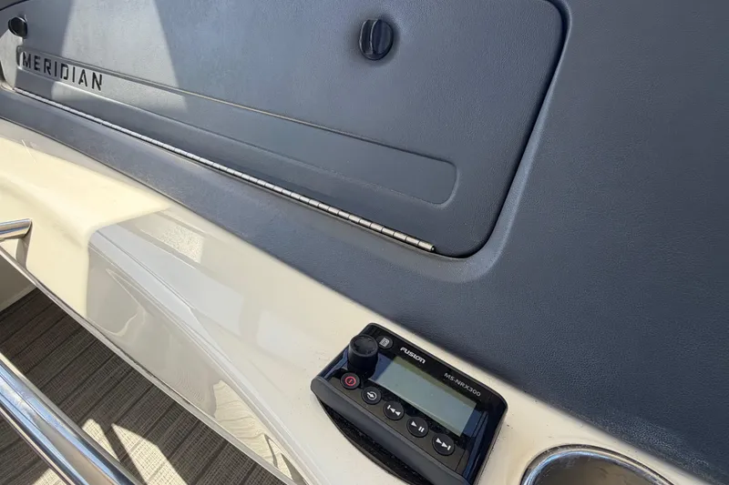 Slide: The Image of Control panel of a 2009 Meridian 441 Sedan yacht with Fusion MS-NRX300. - 21