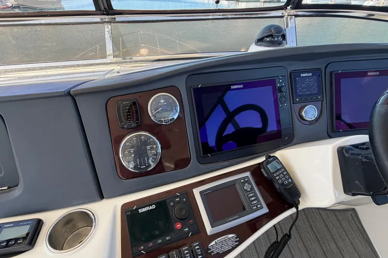 Slide: The Image of 2009 Meridian 441 Sedan helm with Simrad navigation displays and marine radio. - 22