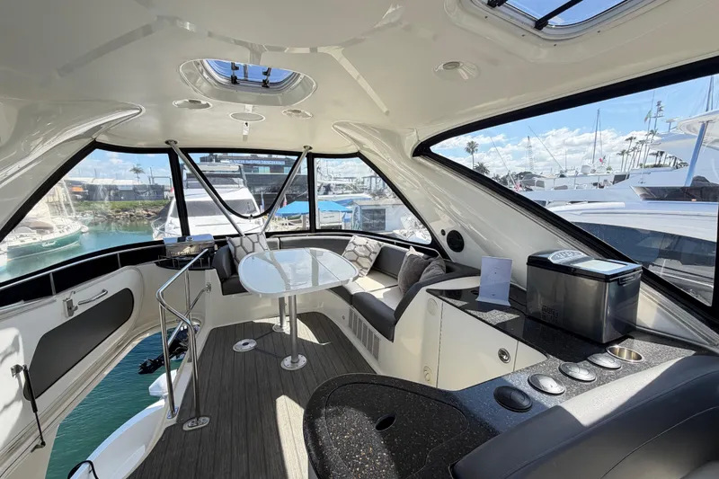 Slide: The Image of Luxurious interior of a 2009 Meridian 441 Sedan yacht with modern seating and table. - 25