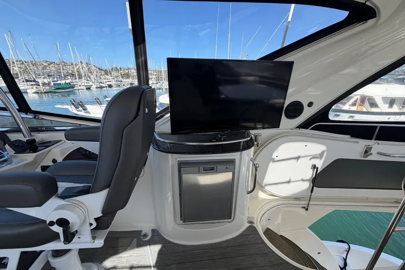 Slide: The Image of Interior of a 2009 Meridian 441 Sedan yacht with helm, seating, and marina view. - 28