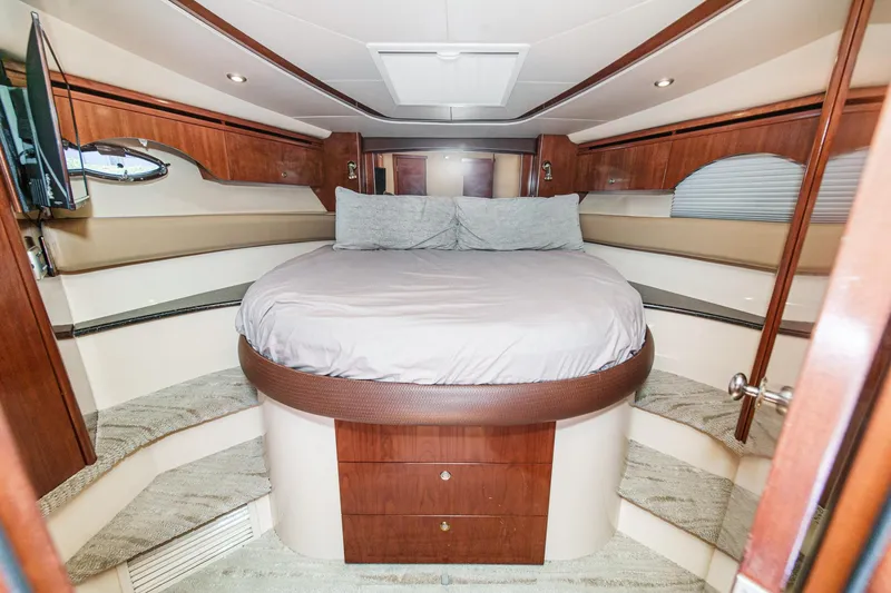 Slide: The Image of Luxurious bedroom interior of 2009 Meridian 441 Sedan yacht with round bed and wood accents. - 33