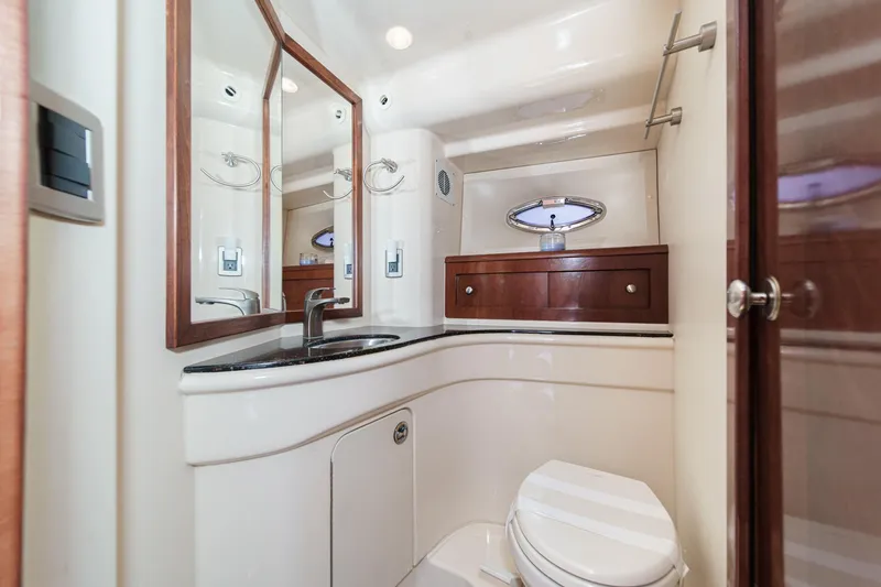 Slide: The Image of Luxurious bathroom in 2009 Meridian 441 Sedan yacht with modern fixtures and wood accents. - 38