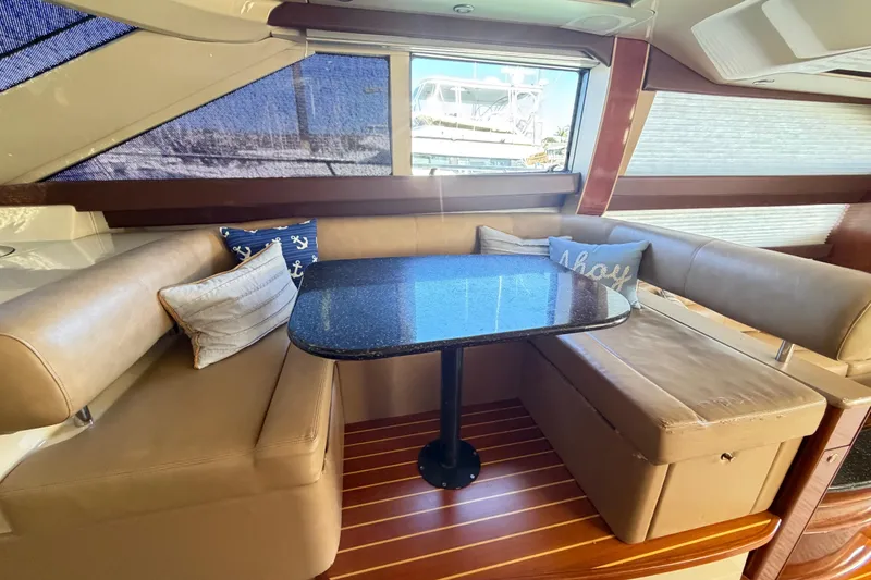 Slide: The Image of Luxurious interior of 2009 Meridian 441 Sedan yacht with plush seating and elegant table. - 5