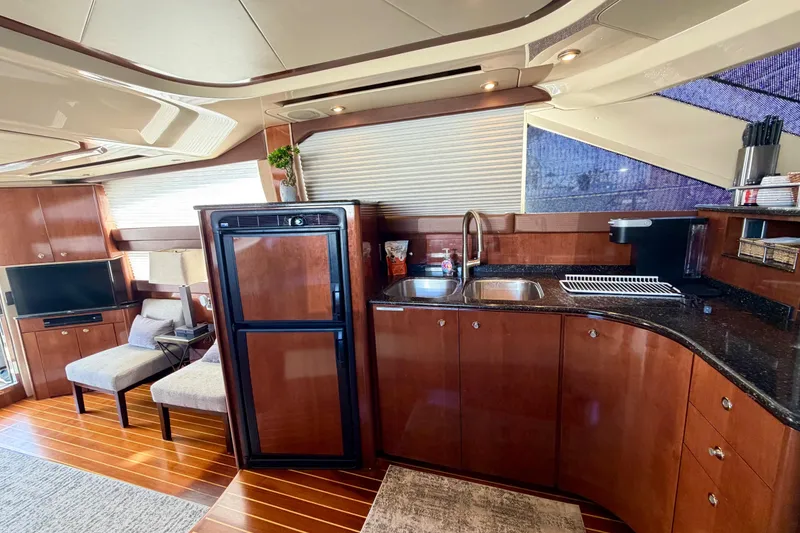 Slide: The Image of Luxurious interior of a 2009 Meridian 441 Sedan yacht with modern kitchen and seating area. - 7