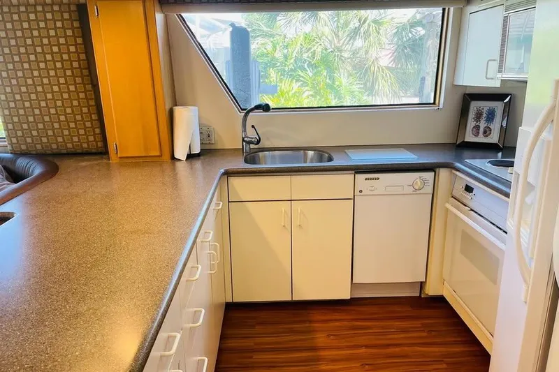 Slide: The Image of Modern kitchen interior of 1991 Hatteras 70 Cockpit Motor Yacht with sleek countertops and appliances. - 10