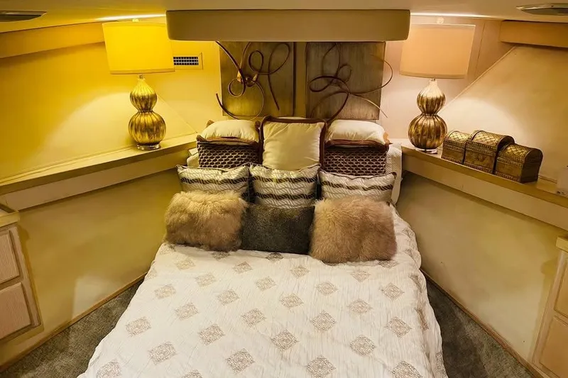 Slide: The Image of Luxurious bedroom interior of 1991 Hatteras 70 Cockpit Motor Yacht with elegant decor. - 14