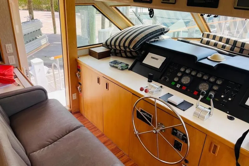 Slide: The Image of Interior helm of 1991 Hatteras 70 Cockpit Motor Yacht with steering wheel and controls. - 16