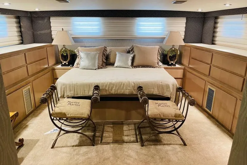 Slide: The Image of Luxurious bedroom interior of 1991 Hatteras 70 Cockpit Motor Yacht with elegant decor. - 17