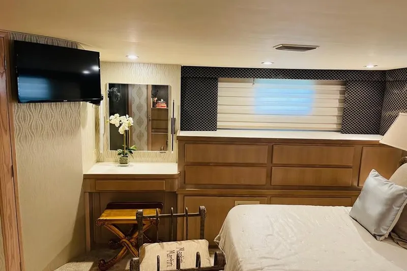 Slide: The Image of Luxurious bedroom interior of 1991 Hatteras 70 Cockpit Motor Yacht with TV and vanity. - 18