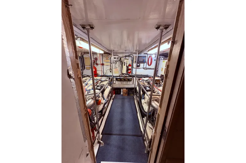 Slide: The Image of Engine room of 1991 Hatteras 70 Cockpit Motor Yacht, featuring organized equipment and piping. - 6
