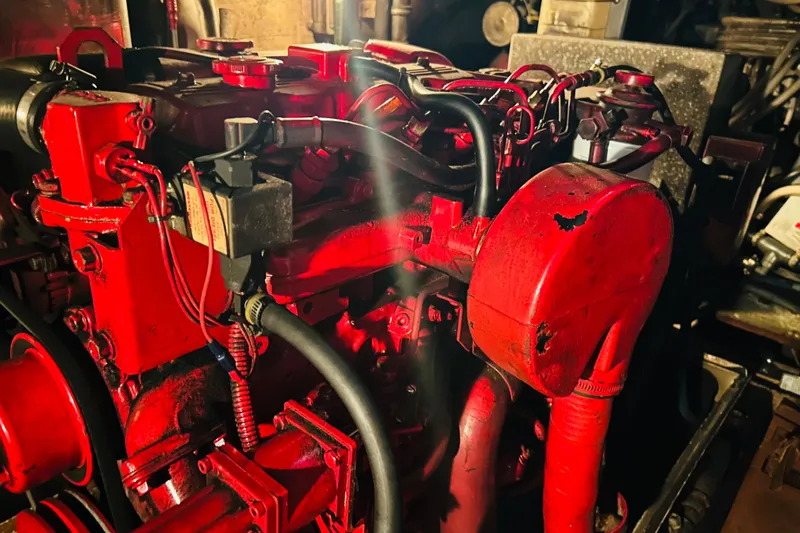Slide: The Image of Engine of a 1991 Hatteras 70 Cockpit Motor Yacht, painted in vibrant red. - 7