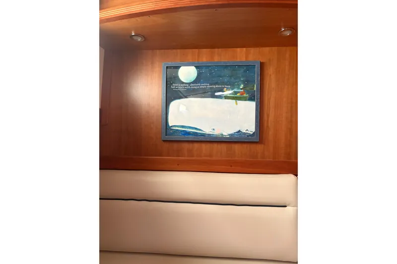 Slide: The Image of Interior of 2020 Sabre 42 Salon Express with framed nautical artwork on wooden wall. - 10